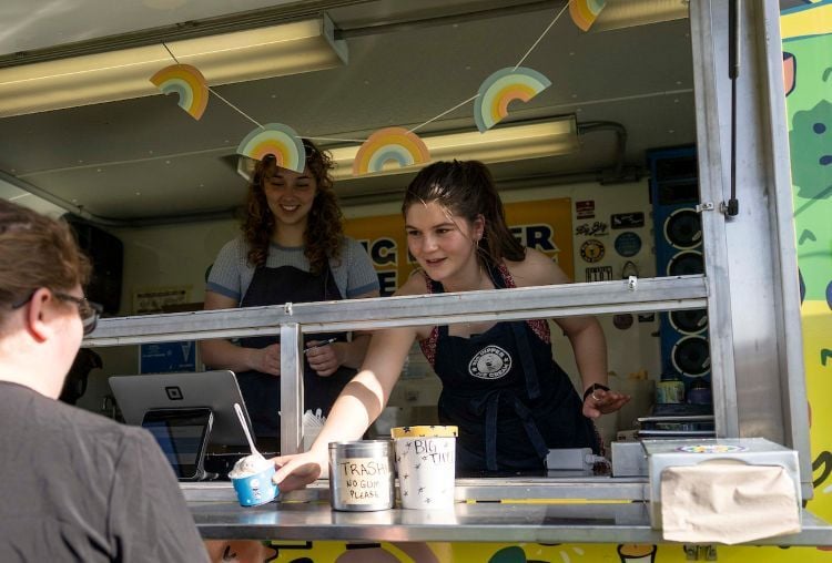 An employee of Big Dipper hands out some ice cream