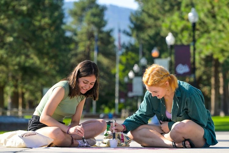 Students painting the sidewalk together