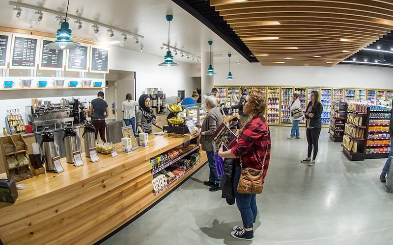 A student waits at the counter for a drink ordered at The Market in the University Center at UM