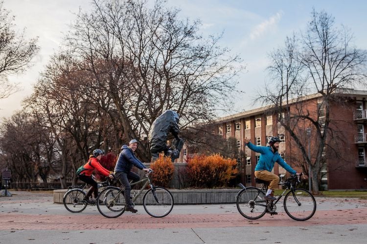 Students biking together on The Oval