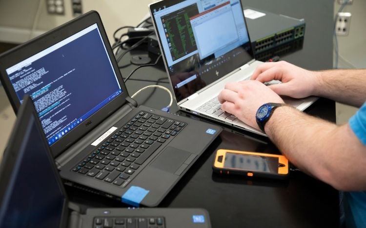 A person coding on a laptop
