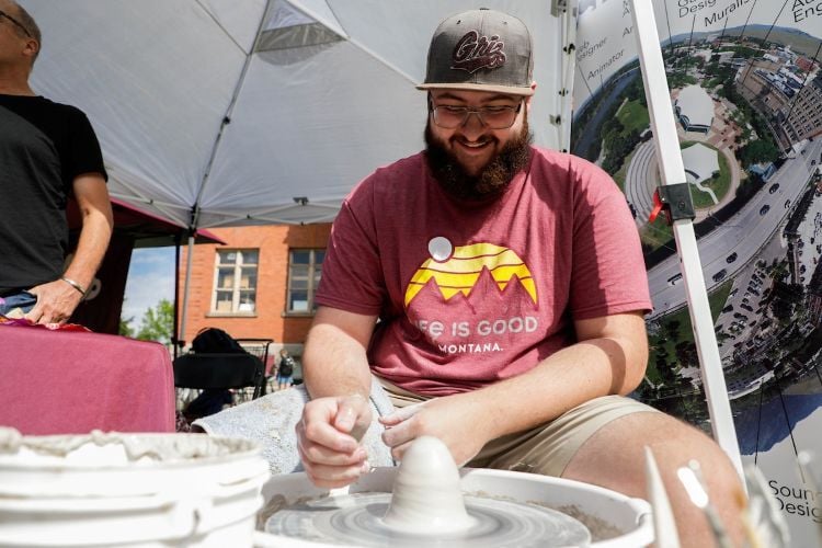 Person creating something on pottery wheel