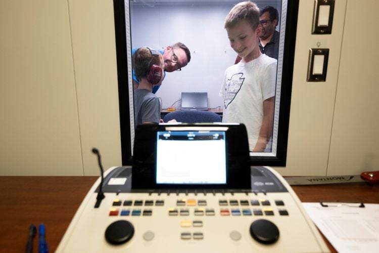 Kids doing an audio test in a soundproof room