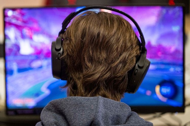Person on computer wearing headphones