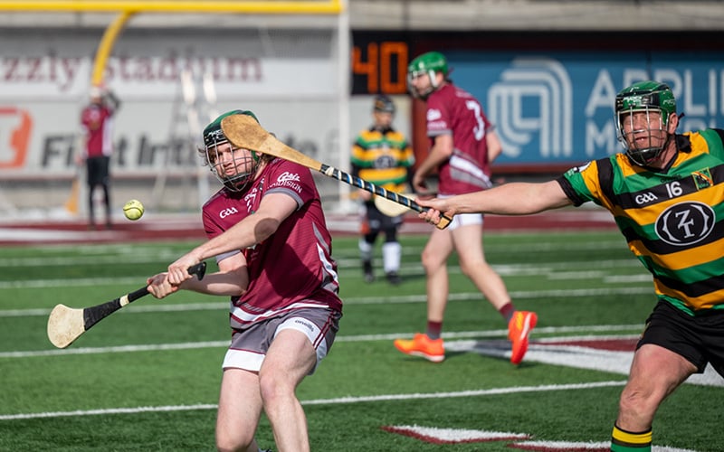 A member of the Club Hurling Team swings at a ball during a match