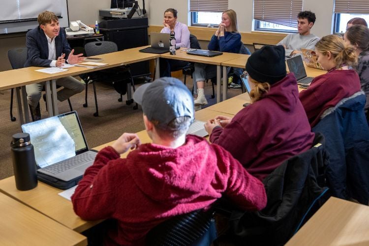 Students sitting around a discussion table during class