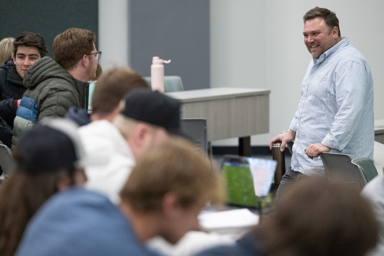 A professor stands at the front of the class