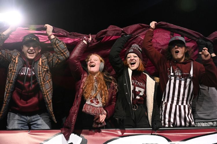 Four members of Zoo Crew cheering during a football game