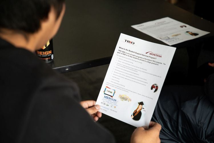 A student looks over a letter from Trio Student Support Services