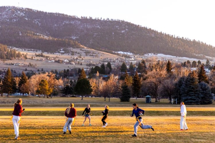 Students playing flag football on campus