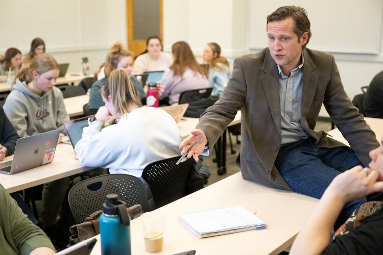 A professor at UM interacts with his class