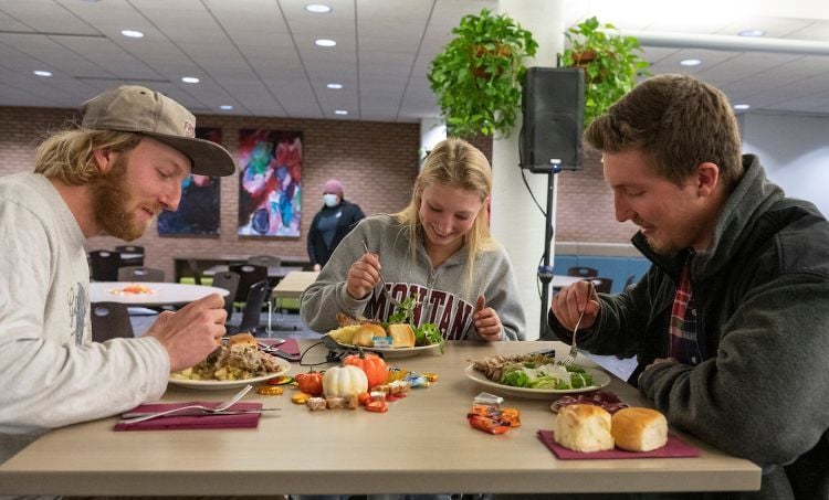 A group of student at a table eating a meal together
