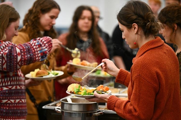 Students scooping food from a buffet line