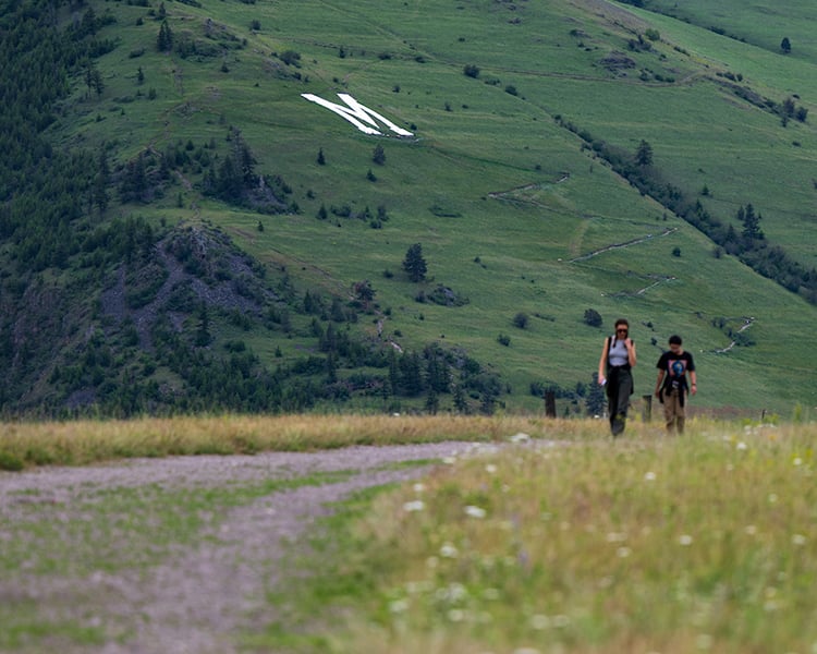 two people walking on waterworks hill with m hill in background