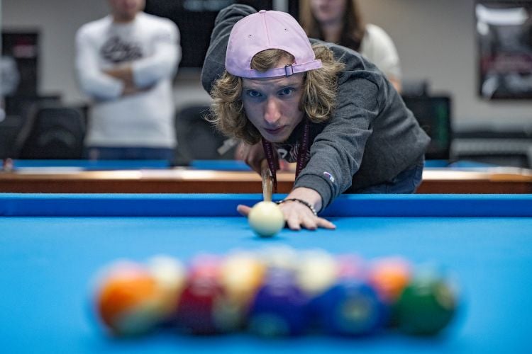 A student lines up to break pool balls in the Gaming Den