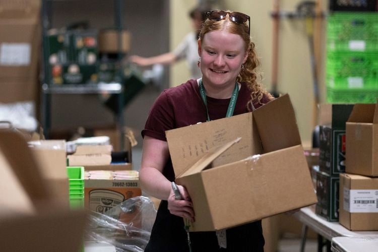 A staff member volunteering at the Missoula Food Bank