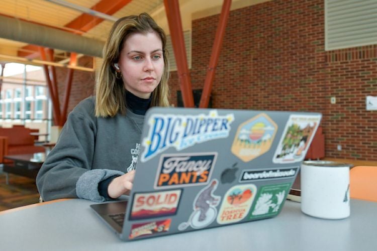 A student studying on our laptop