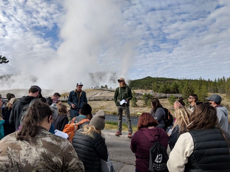 Students in the Parks, Tourism and Recreation Management Program listen to an instructor while at Yellowstone National Park