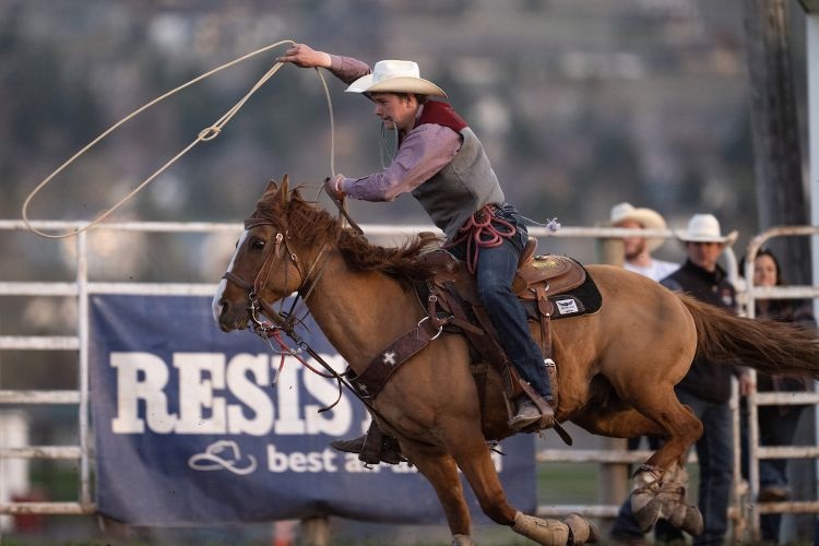 A UM Rodeo student-athlete swings a lasso atop a horse