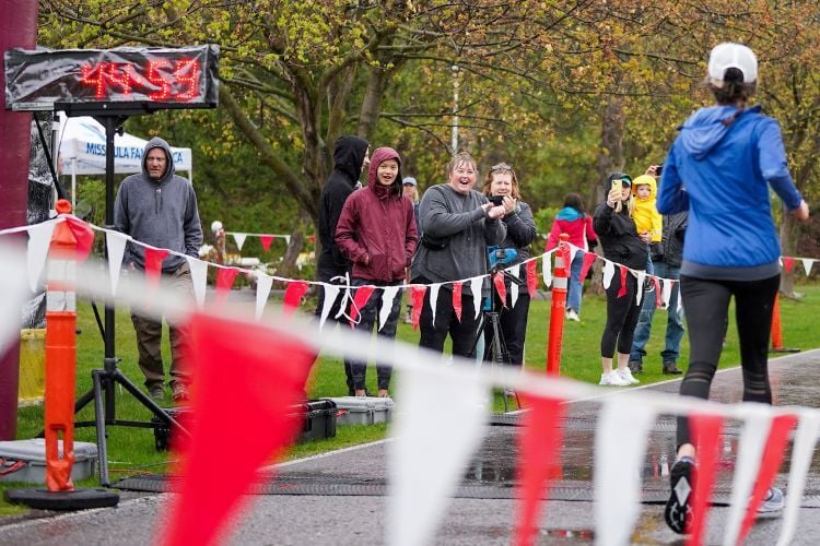 Spectators cheering on a runner during a race event