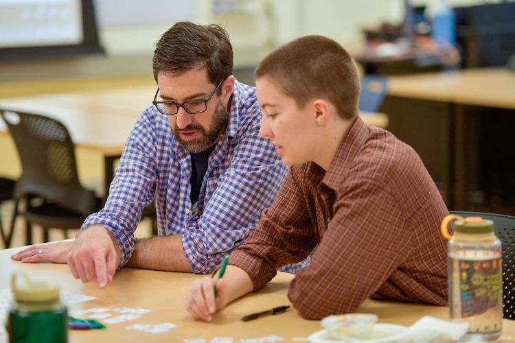 A professor helping a student with work