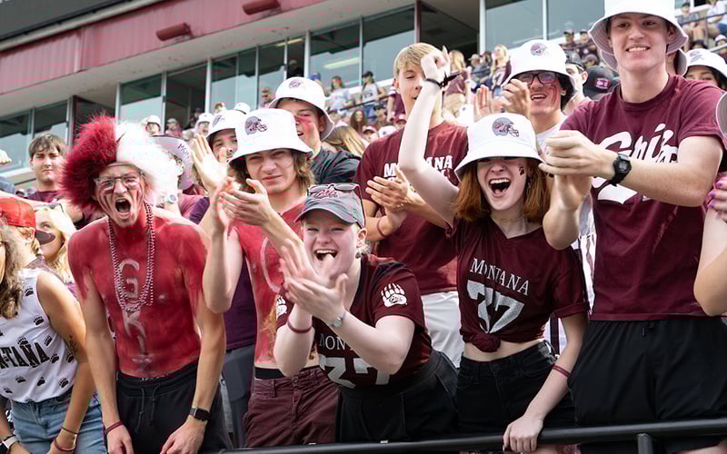 Students in the Zoo Crew fan club cheer wildly at a Griz football game
