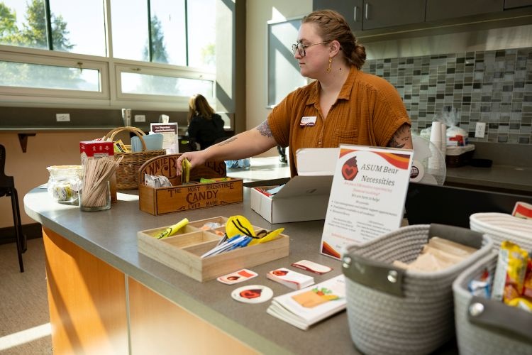 A student working at the Bear Necessities Food Pantry