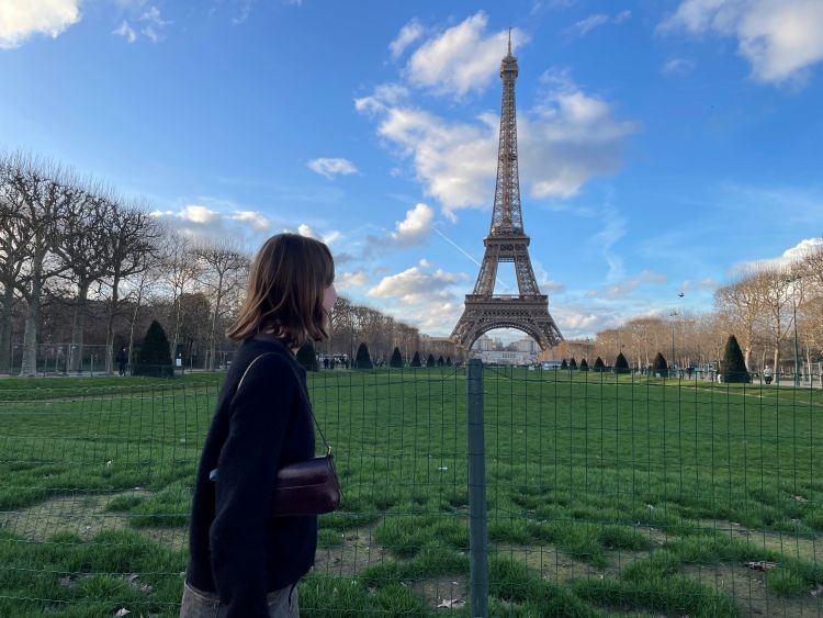 Author, Madison Knapp, looking back at the Eiffel Tower in France