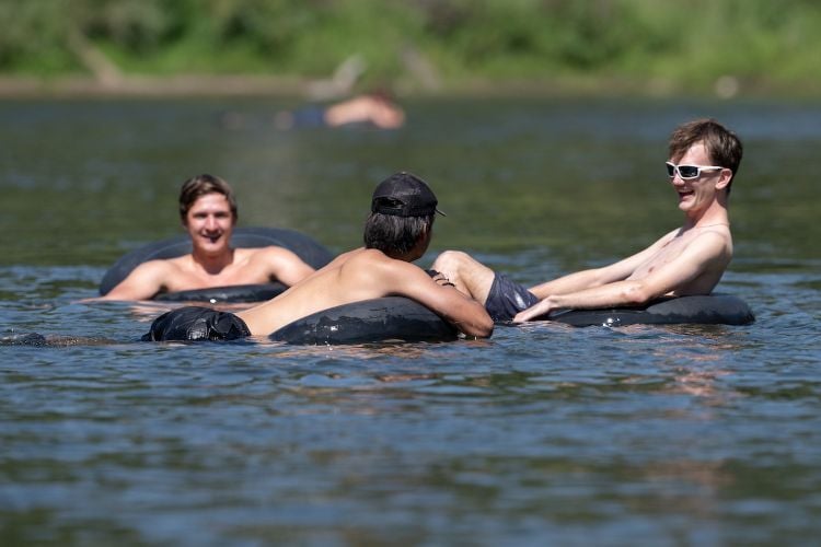 Three students enjoy floating on the Clark Fork River