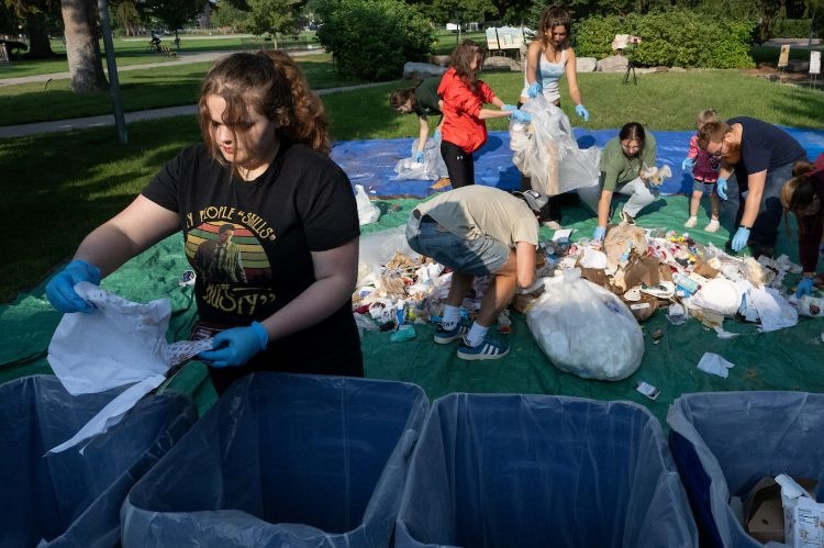 People sorting through trash