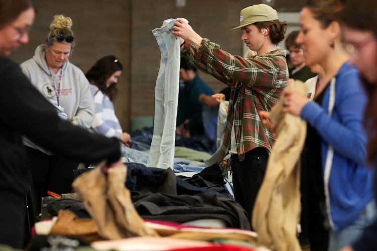 People checking out clothes on a table
