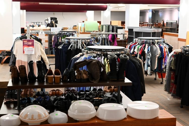 Clothes on racks and shoes and dishware