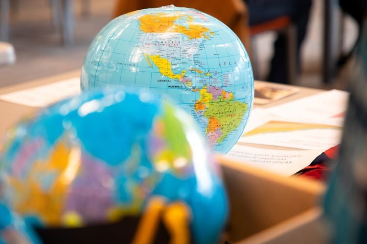 Inflatable globes sit on a desk