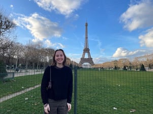 Author Madison Knapp Standing in Front of the Eiffel Tower