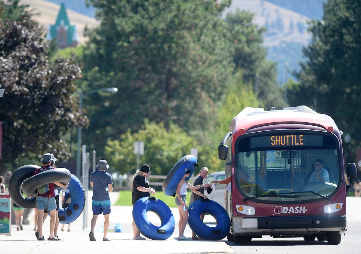 Students lined up with inner tubes to ride the special fiver float shuttle offered by UDash