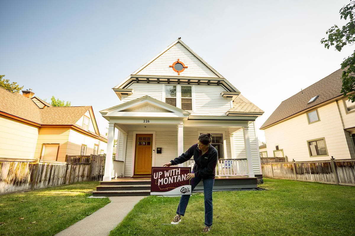 Property owner putting a Montana sign on their yard in the University District