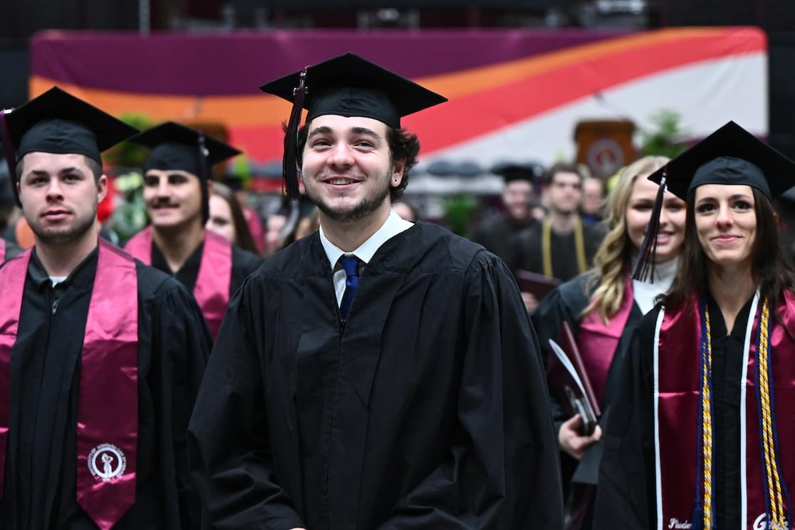 UM students smiling at graduation
