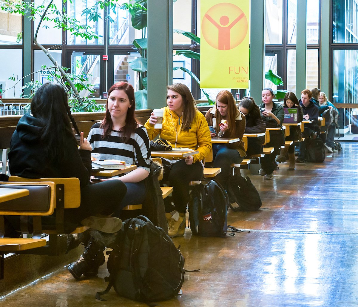 A row of students eating and studying at the University Center